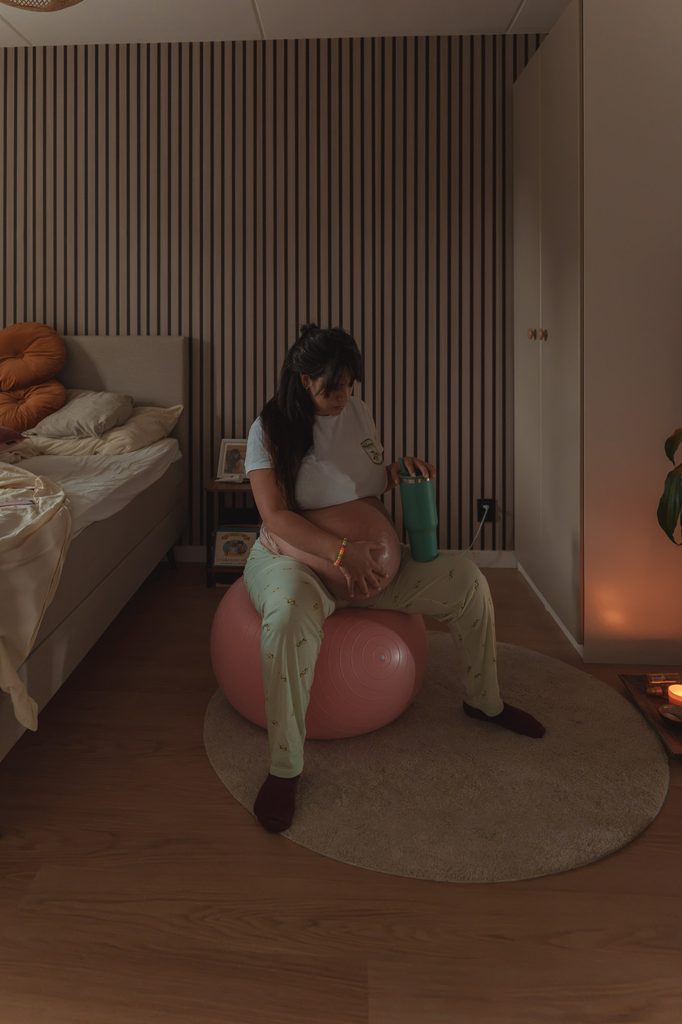 Pregnant mother walking at home during early labour, birth photography Netherlands
