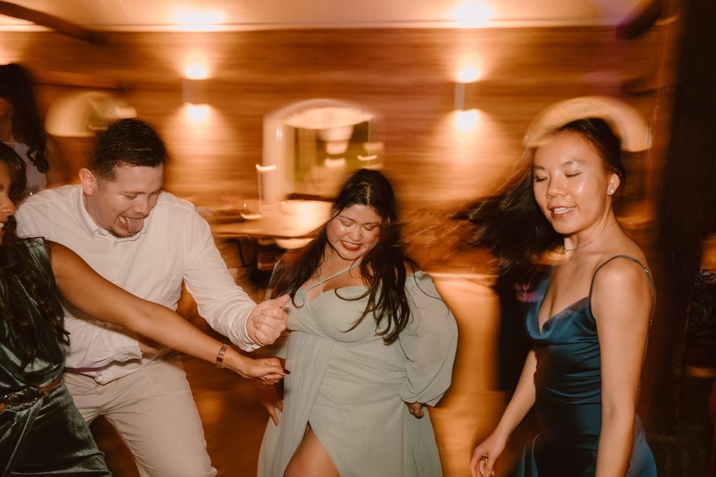 Friends dancing together at the wedding party, Mexican-Dutch wedding in the Netherlands