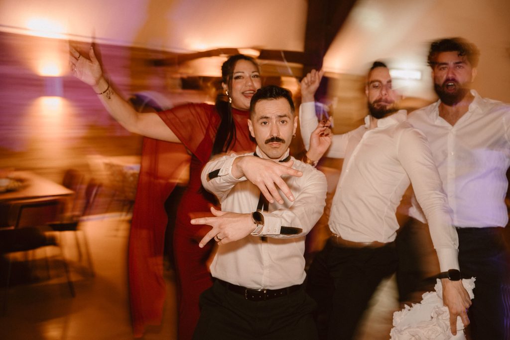 Guests laughing around the Mexican piñata, Mexican-Dutch wedding in the Netherlands