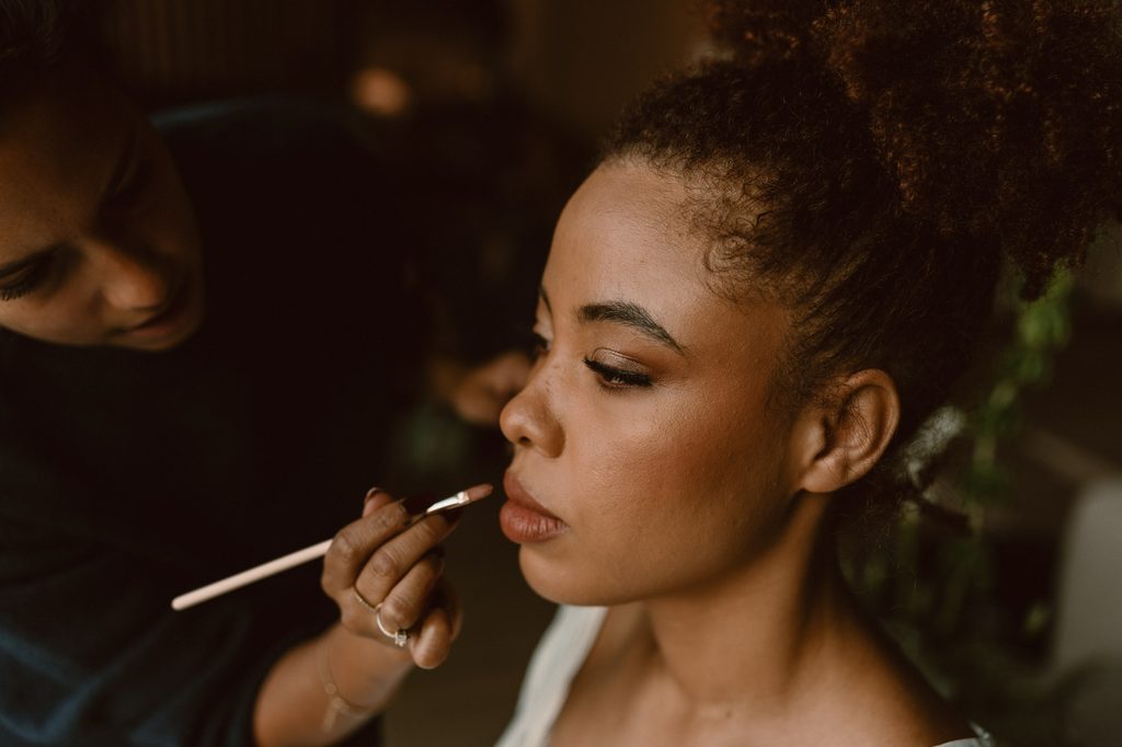 Bride getting her make-up done on the wedding morning, Mexican-Dutch wedding in the Netherlands