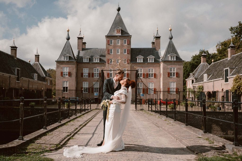 Bride and groom in front of a castle, Mexican-Dutch wedding in the Netherlands