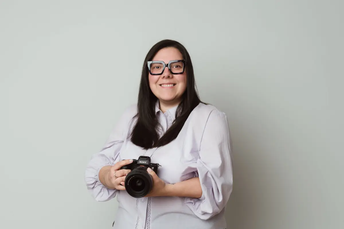 Ka Monge, family and birth photographer in Zoetermeer, smiling with her Sony camera